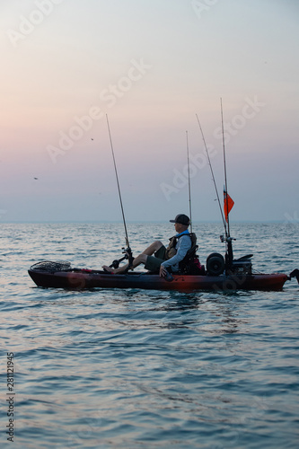 Young Man Kayak Fishing at Sunrise in Canada