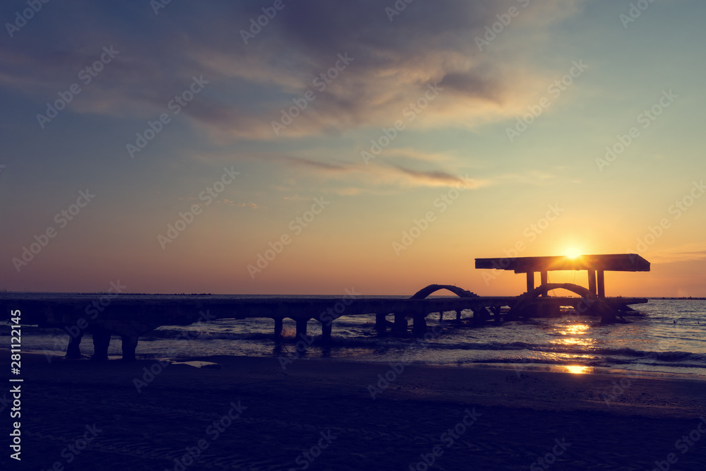 Vintage look of an amazing sunrise over old and abandoned pontoon