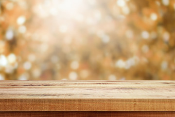 Wooden table and blurred bokeh autumn background.