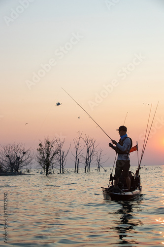 Young Man Kayak Fishing at Sunrise in Canada