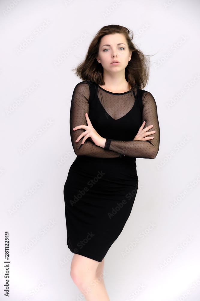 Horizontal Portrait of a pretty slim beautiful fashionable adult girl with beautiful brunette hair in a black dress. It should be in full growth, talking showing different poses and emotions Horizontal Portrait of a pretty slim beautiful fashionable adult girl with beautiful brunette hair in a black dress. It should be in full growth, talking showing different poses and emotions