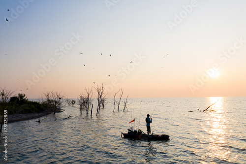 Young Man Kayak Fishing at Sunrise in Canada