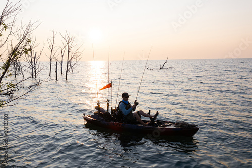 Young Man Kayak Fishing at Sunrise in Canada