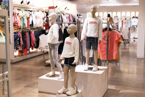 Children's clothing on mannequins, on hangers in stores. The concept of shopping,