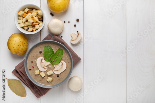 mushroom cream soup on white wooden board. Top view