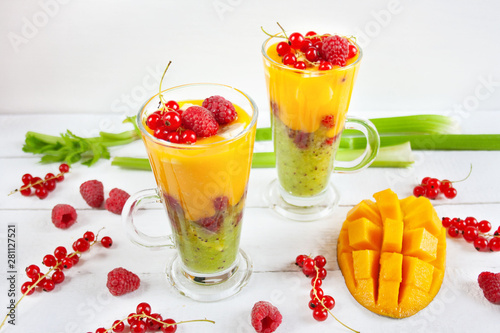 A multi-layered smoothie with mango, kiwi, celery, currants and raspberries