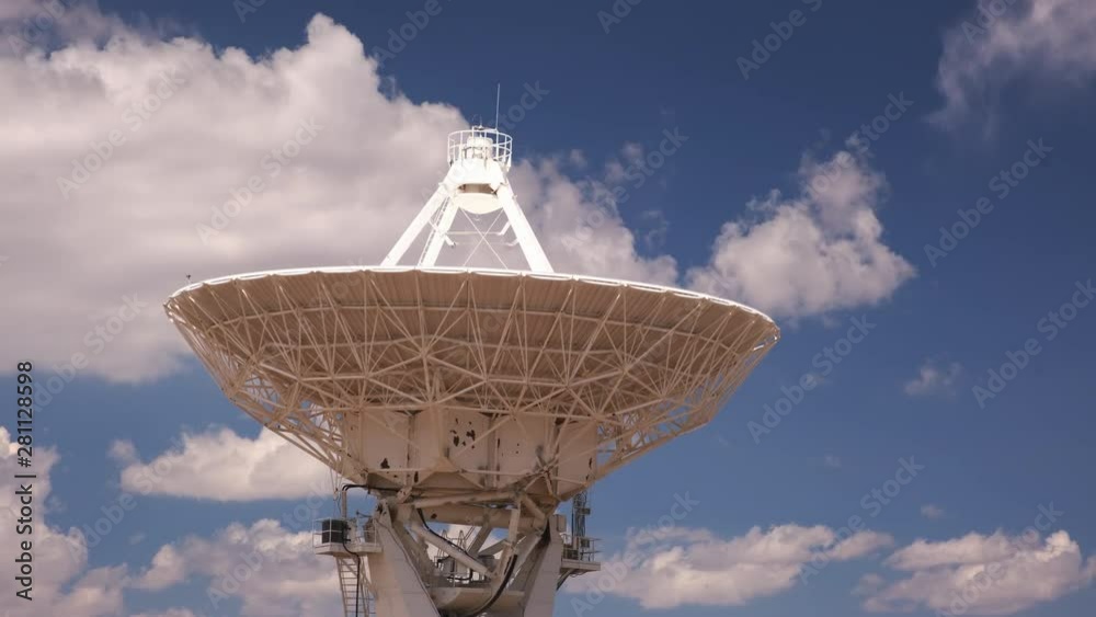 Satellite antenna in time lapse with clouds