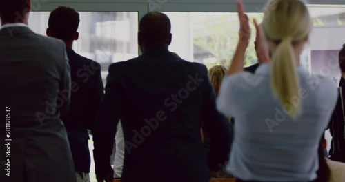 Business people applauding male speaker in a business seminar 4k