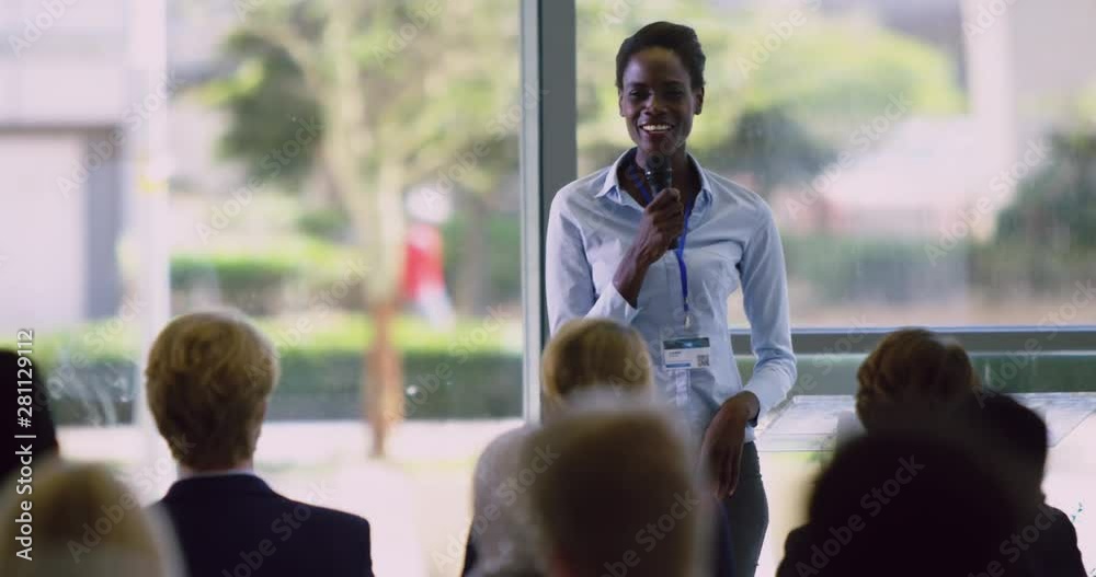 female speaker speaks in a business seminar at modern office 4k