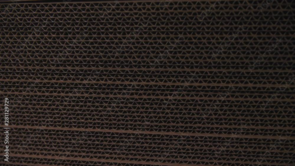 putting cardboard paper on pile by machine at plant closeup