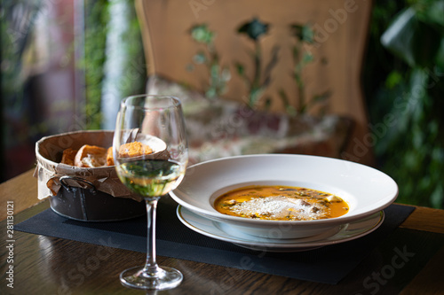 evening in restaurant with wine, pumpkin cream soup and garlic toasts
