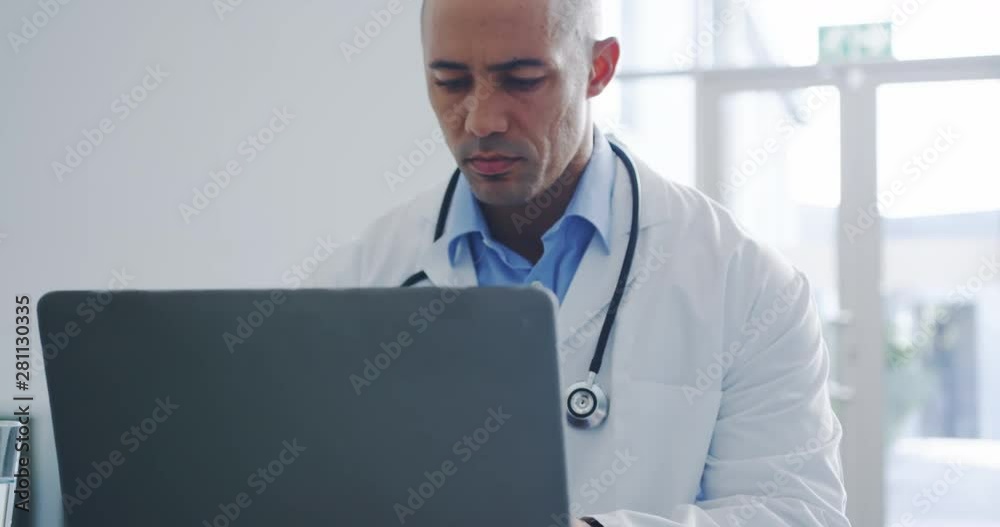 Male doctor using laptop in office 4k