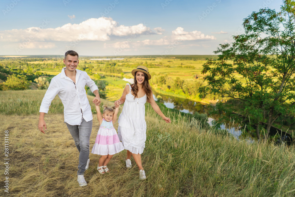 Happy family playing in the fresh air on the meadow Happy family playing in the fresh air on the meadow