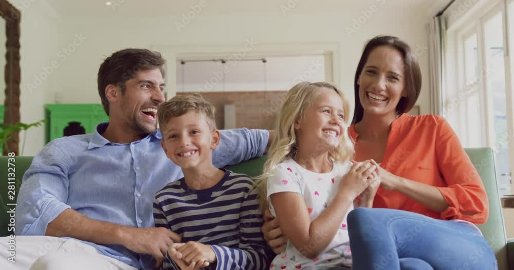 Family playing together on sofa in living room at home 4k Family playing together on sofa in living room at home 4k