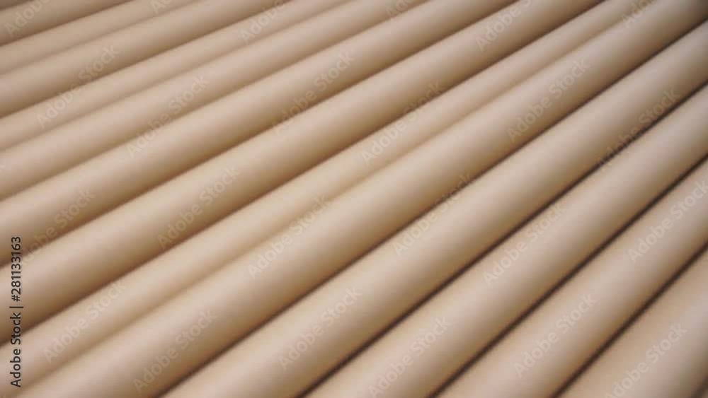 brown folds of new cardboard paper on conveyor closeup