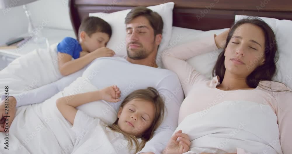 Family sleeping together on bed in bedroom at home 4k Family sleeping together on bed in bedroom at home 4k