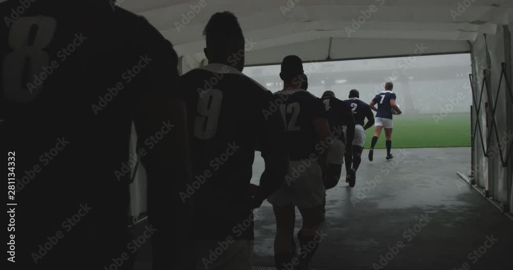 Male rugby players running together in a row at the entrance of stadium 4k