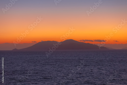 Beautiful sunset with orange sky with Aegean Sea island background