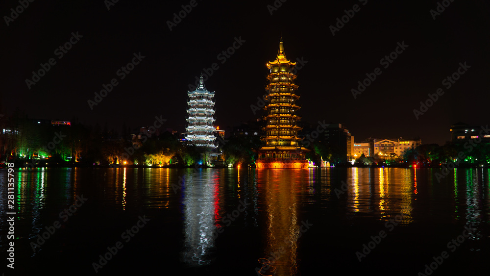 The Sun and Moon Twin Pagodas during evening. View of Shanhu Lake (Fir Lake) in downtown of Guilin, China