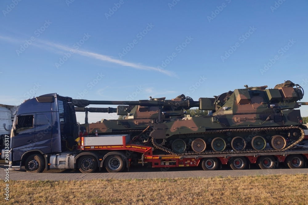 Over-standard, atypical road transport. A howitzer on the tank chassis.