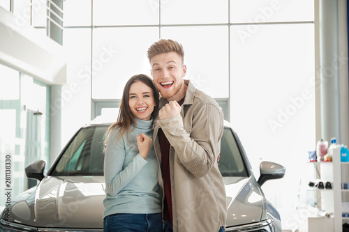 Happy couple buying new car...