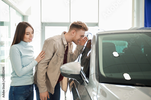 Couple choosing new car in ...