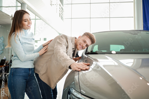 Couple choosing new car in ...