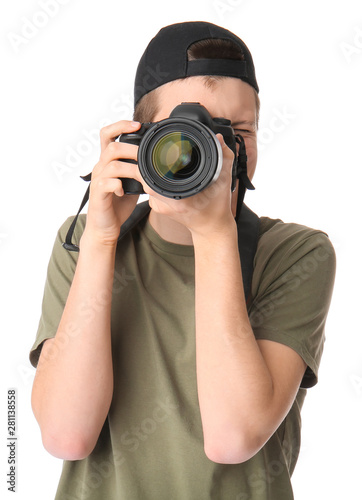 Teenage boy with photo camera on white background