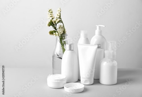 Set of cosmetic products on light background photo