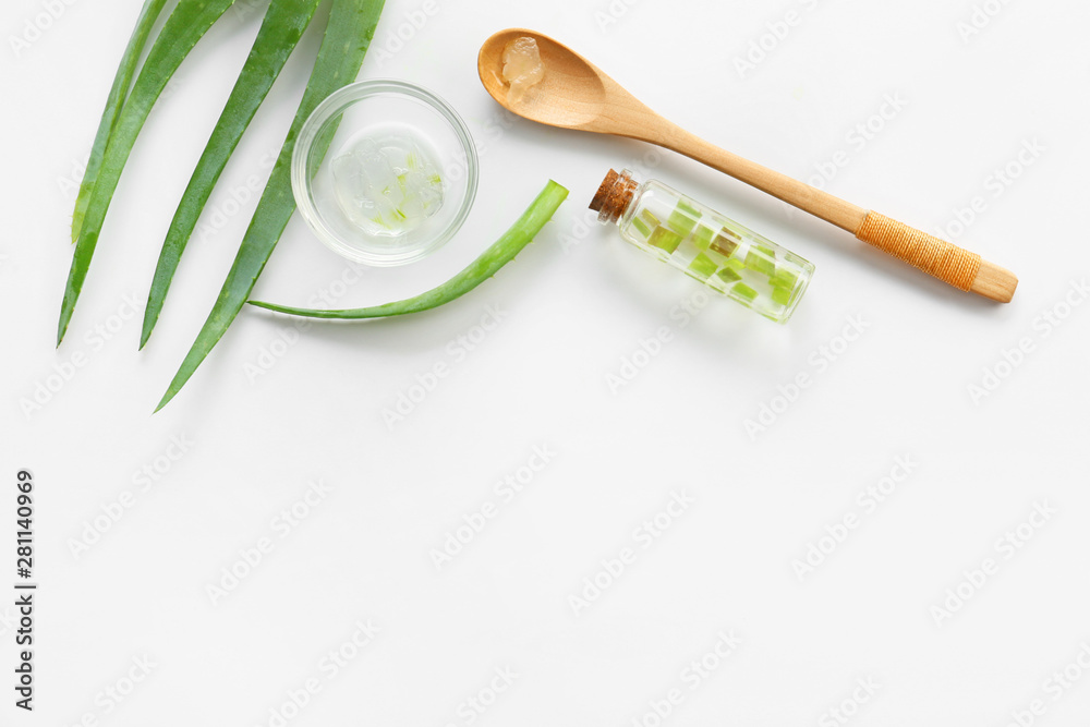 Fresh aloe leaves with essential oil on white background Fresh aloe leaves with essential oil on white background