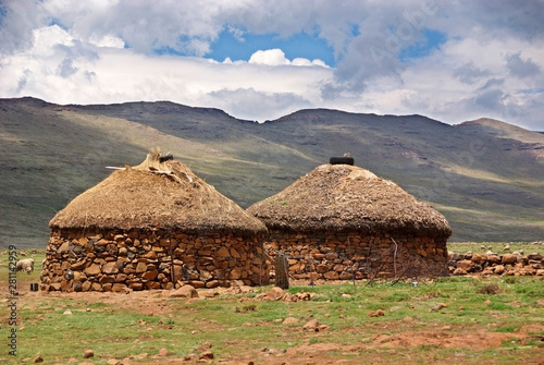 Traditional style of housing in Lesotho is called a rondavel. The roof itself is made out of thatch that is sewn to the wooden braces with rope photo