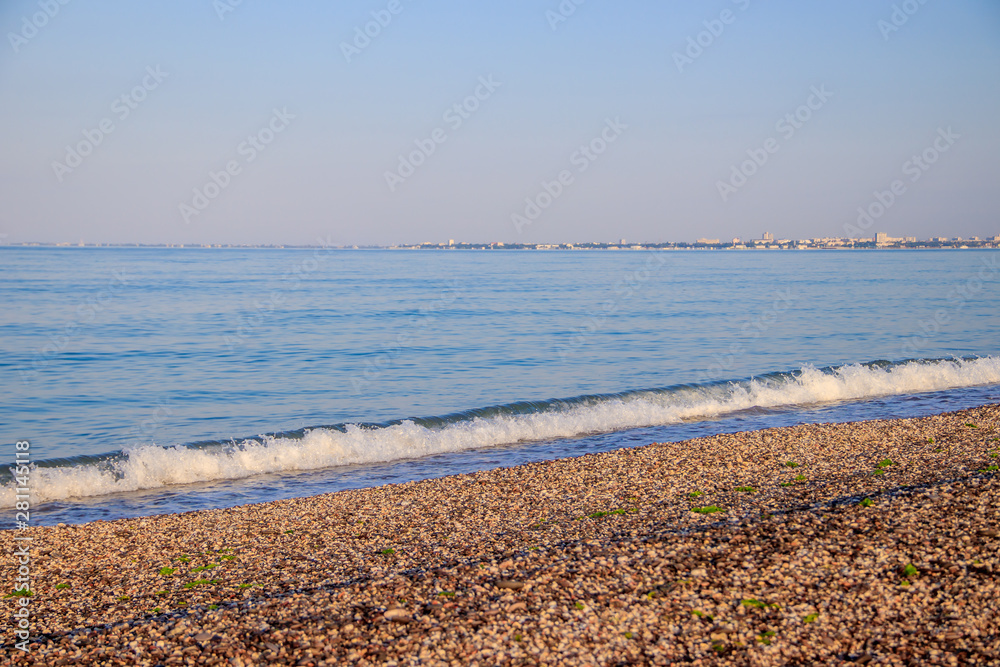 Sea wave in the morning light. Sea wave and beach. Sea wave background. Crimea. Wave and pebble beach. Rest and travel to the sea.