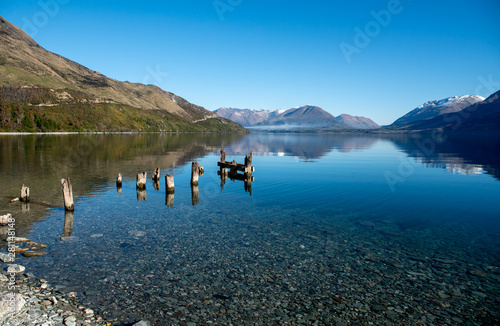 Fototapeta Naklejka Na Ścianę i Meble -  Ruins of an old wooden jetty in Lake Wakatipu near Glenorchy