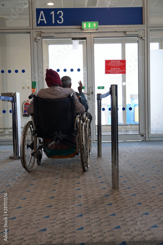 Elderly disabled people waiting to board a plane. Priority is given to disabled when boarding a plane    © Thomas