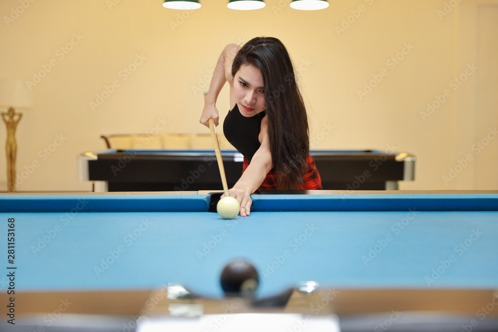 beautiful and sexy asian woman in black dress playing billiard or snooker  on blue pool table with happy smiling face during holiday vacation Photos |  Adobe Stock