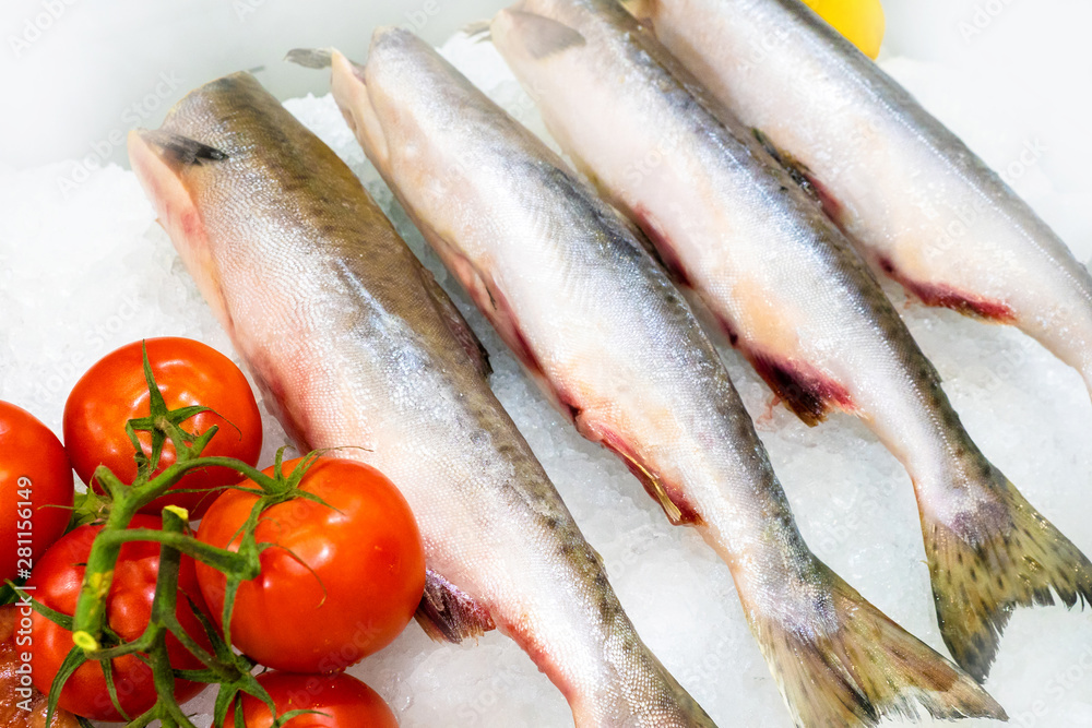 Chilled fish. Professional cutting of fish. Fish carcasses lying on the ice. Fish on display. Seafood shop. Sale of seafood. Chilled fish. Professional cutting of fish. Fish carcasses lying on the ice. Fish on display. Seafood shop. Sale of seafood.