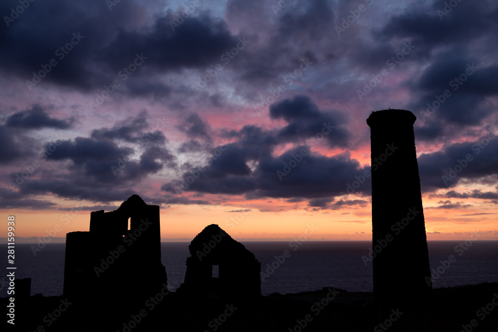 Silhouette of Wheal Coates abandoned tin mine in Cornwall England after sunset with Whim and Stamps Engine house and smoke stack