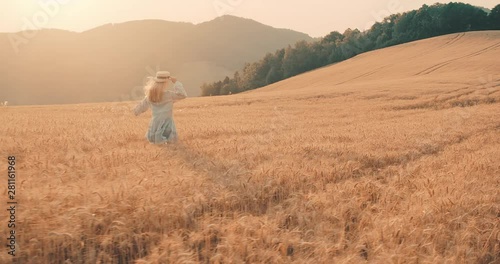 Wallpaper Mural Beautiful woman walking in wheat field, sunset sun rays, Slow motion 4K. Torontodigital.ca