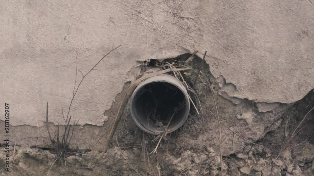 Pulling Away From Exposed Pipe Drain on Side of Building Pulling Away From Exposed Pipe Drain on Side of Building