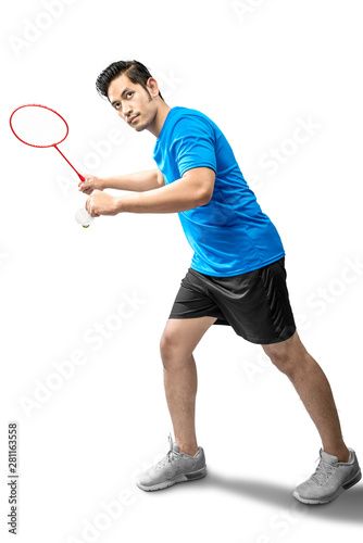 Asian man with badminton racket holding shuttlecock and ready in serve position