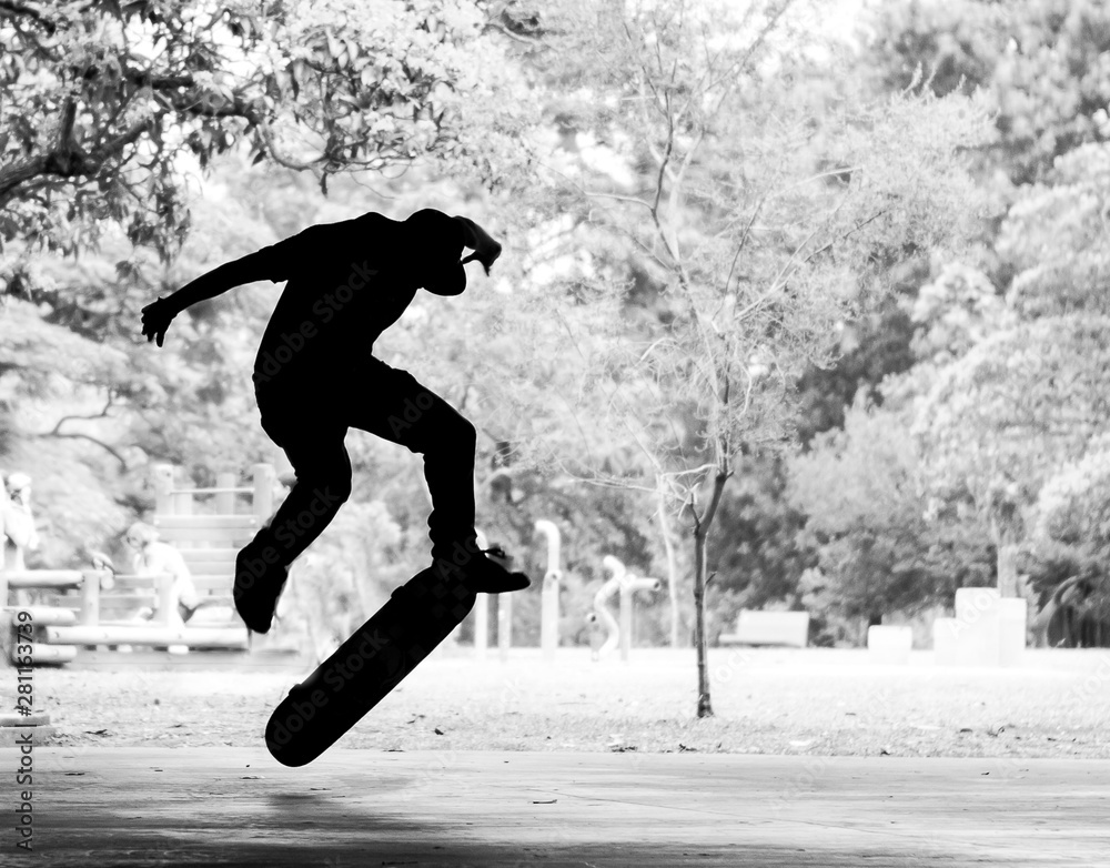 Boy practicing street skateboard, freestyle in black and white.