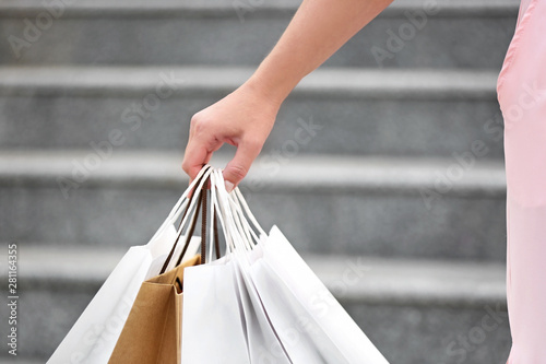 Woman with shopping bags outdoors, closeup