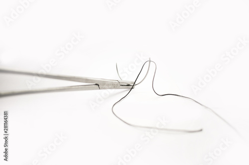 Medical instruments Surgical suture with Forceps on white background. - Image