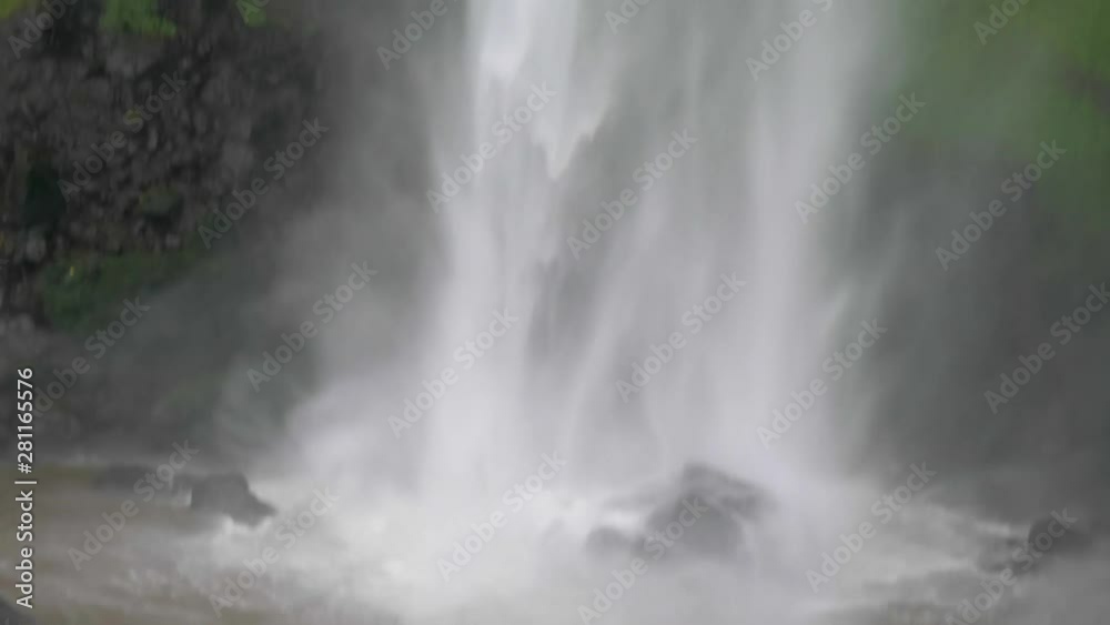 Close up shot tracking falling water down sipi falls in rural Uganda. Close up shot tracking falling water down sipi falls in rural Uganda.