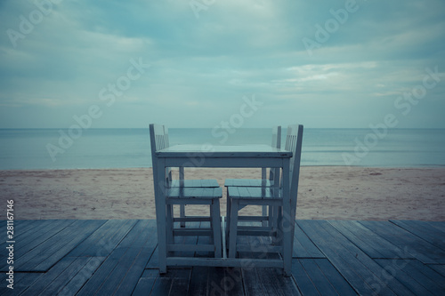 Vintage tone of White table for dinner on the beach and sky