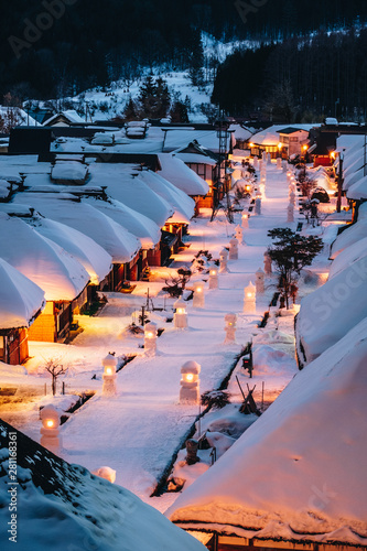 Light up illumination with thatched roof house,  village made of over 30 traditional Japanese houses  and snow covered street in Ouchi Juku village, Fukushima, Tohoku, Japan in Winter