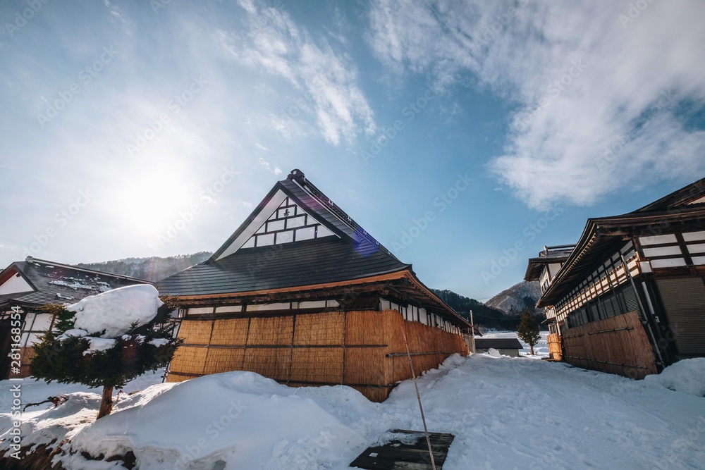 Thatched roof house,  village made of over 30 traditional Japanese houses  and snow covered street in Ouchi Juku village, Fukushima, Tohoku, Japan in Winter