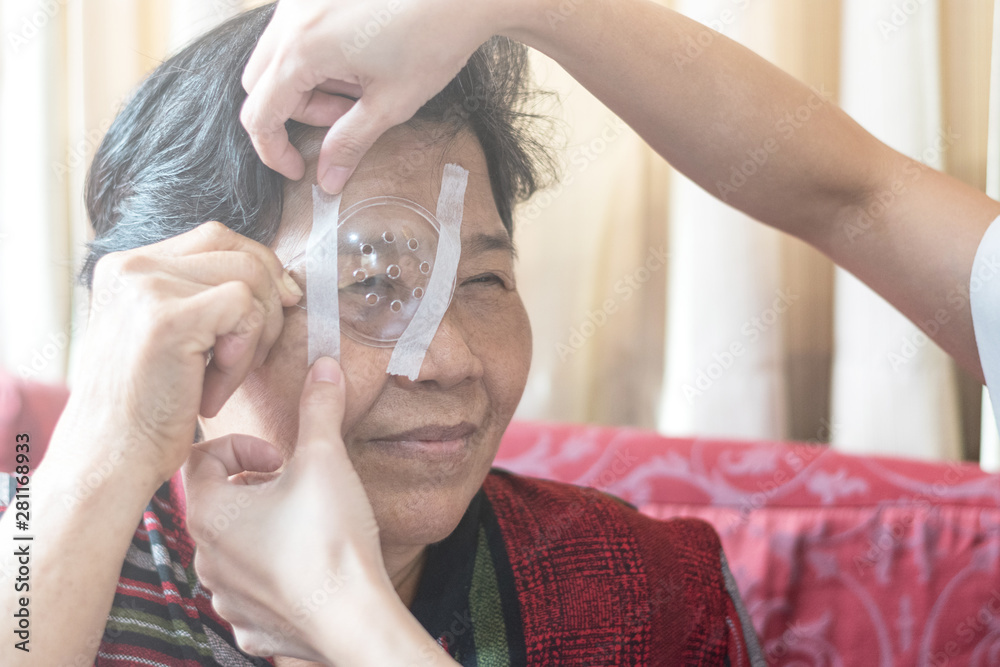 Cataract treatment after surgery by caregiver concept. Asia old woman