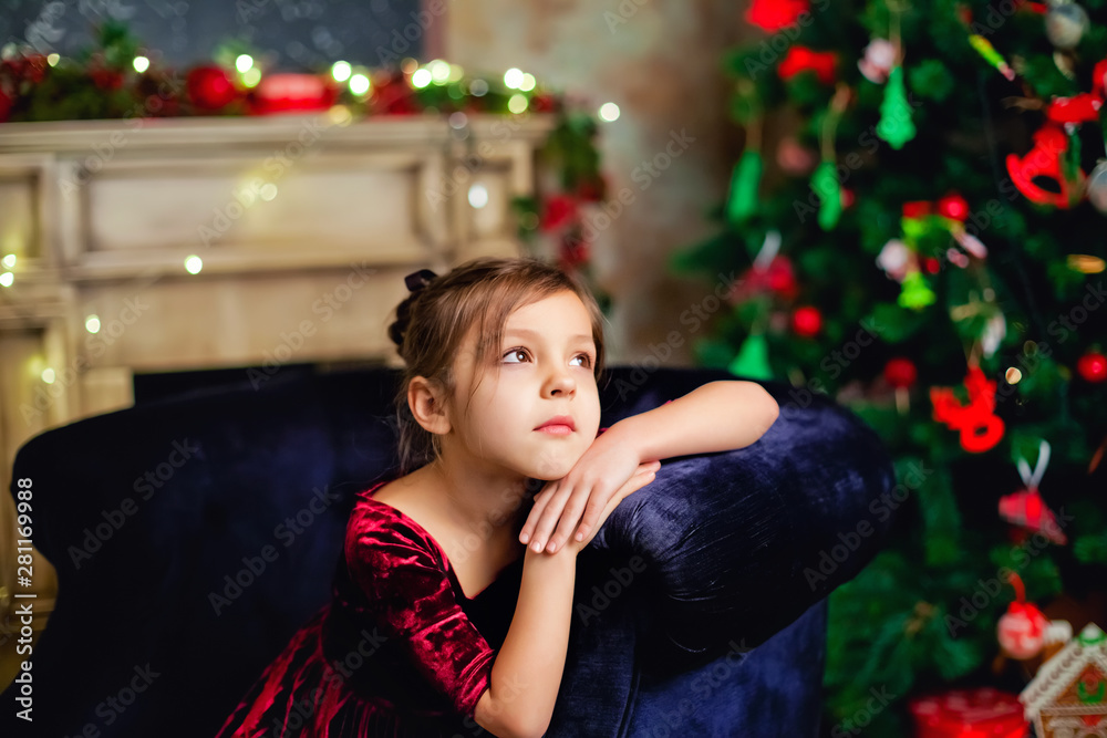 portrait of a girl near the Christmas tree portrait of a girl near the Christmas tree