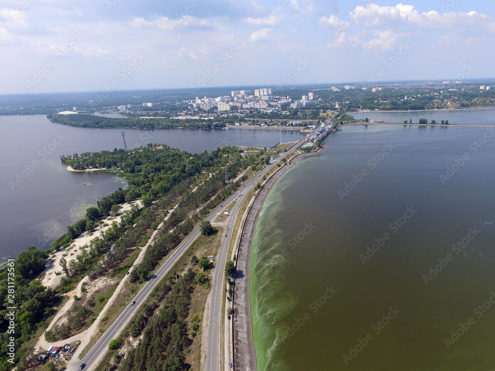 Green algae on the surface of the water. blooming water as a consequence of the dam structure and environmental pollution. Storage pool of power station. (drone image). Kiev ,Ukraine